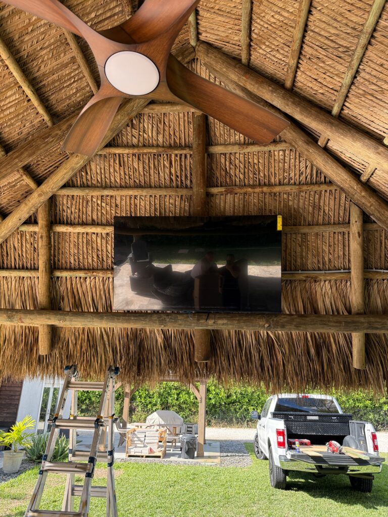 Outdoor entertainment setup with mounted TVs