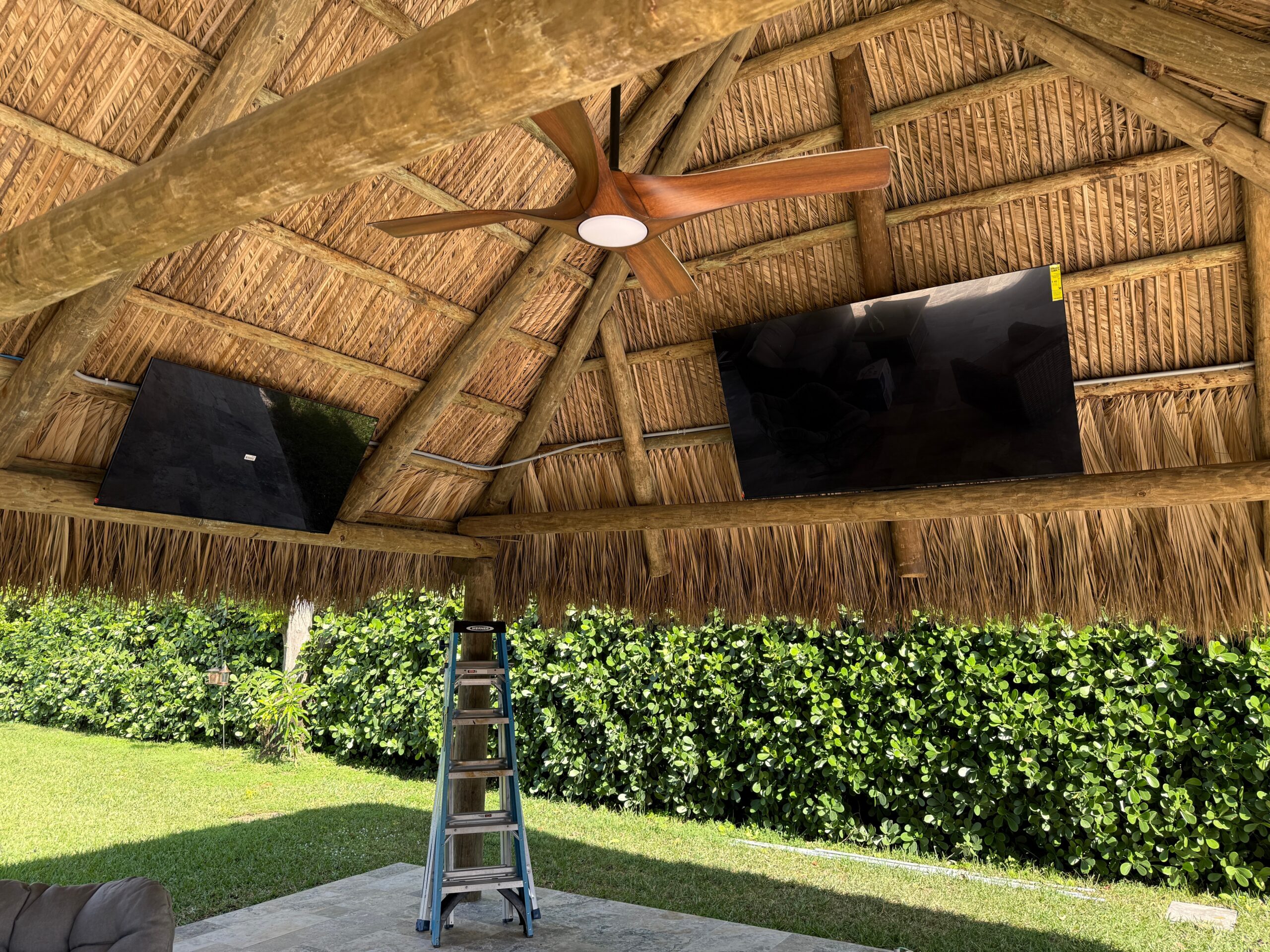 Outdoor entertainment setup with mounted TVs